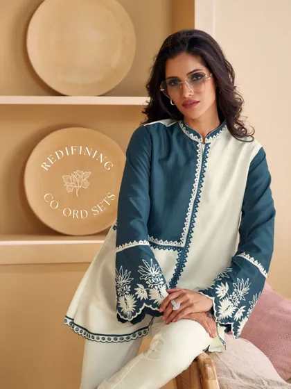 For a modern and chic look, I offer contemporary co-ord sets. This deep teal and ivory set features beautiful floral embroidery, blending traditional craft with a fresh, modern silhouette.