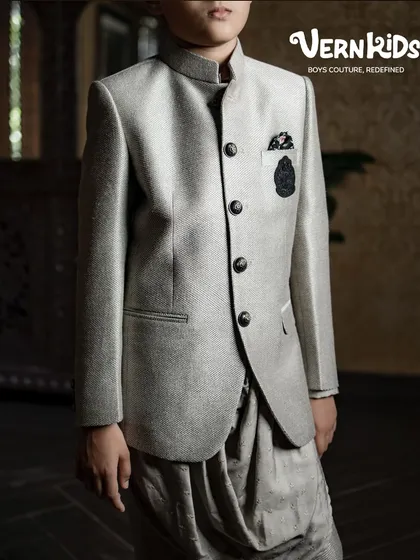 A close-up of our grey Jodhpuri jacket paired with a dhoti-style pant. This angle highlights the unique silhouette and texture of the fabric, a perfect blend of tradition and trend.