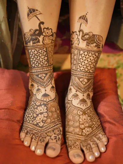 Beautifully detailed bridal feet mehendi. The design features elephants, jhumkas, and lotus flowers, ensuring the bride is adorned from head to toe.