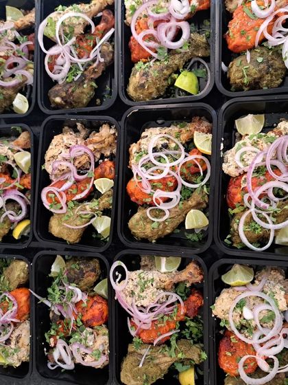 An overhead view of a large order of Tangdi Kebab Platters, showing my capability to handle catering for events of all sizes.