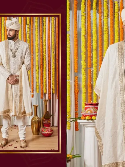 A full-length view of a groom's majestic wedding sherwani against a festive backdrop. This ivory piece with detailed embroidery and a matching safa embodies the grandeur of Indian wedding traditions.