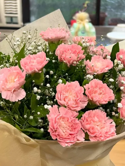 A beautiful bouquet of pink carnations that was part of a baby shower gift set. Sometimes, the simplest things like fresh flowers bring the most joy to a celebration.