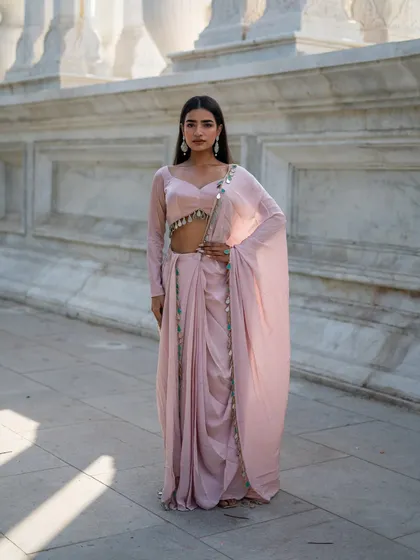 Another beautiful piece from our Pastel Pink Edit. This pre-draped dhoti saree in a soft pink is both modern and elegant.