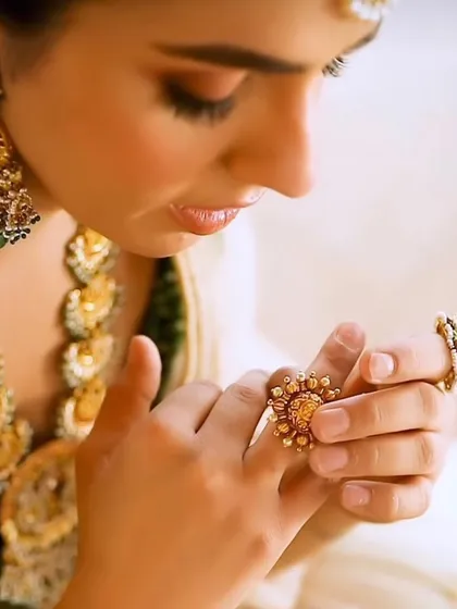 The beauty of bridal jewellery is in the details. This close-up shot focuses on a stunning, oversized ring from a temple jewellery set, highlighting the intricate craftsmanship that goes into each piece.