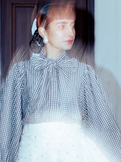 An artistic, light-streaked photo that captures the mood of my classic black and white ensemble.