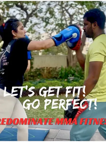 Let's get fit, go perfect. A female student practices her boxing with a coach in an outdoor setting, showing our commitment to versatile training.