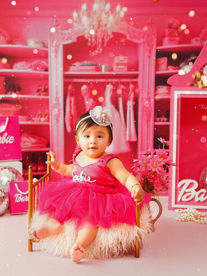 Posing in her own little Barbie world, this baby girl is surrounded by pink, glitter, and glamour. I love creating these elaborate, immersive sets.
