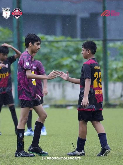 A moment of sportsmanship and teamwork between two players after a play.