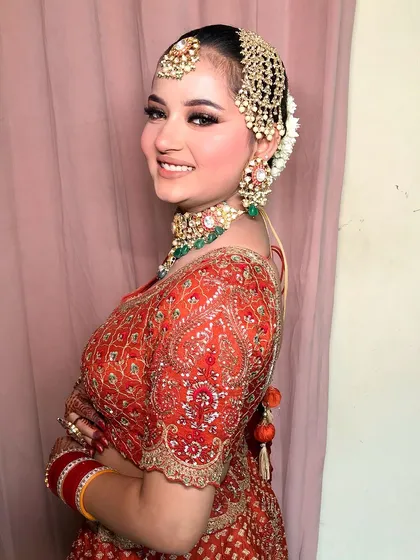 A side view of the bride, showing her elegant bun and the way the passa is placed.