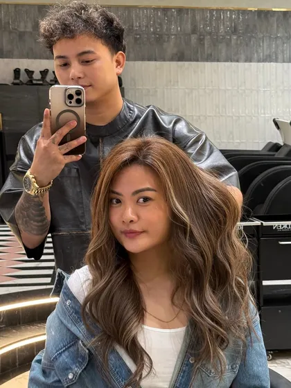 A selfie with a happy client after her ash blonde hair transformation. The color is bright and beautiful, and her smile says it all.