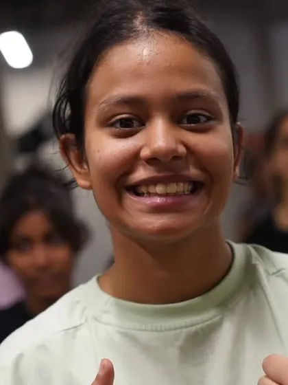 A happy student, proud of her progress in the intensive class.