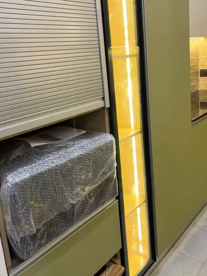 A closer look at the rolling shutter appliance garage. This is a practical solution to keep your countertop clear and your kitchen looking organized.