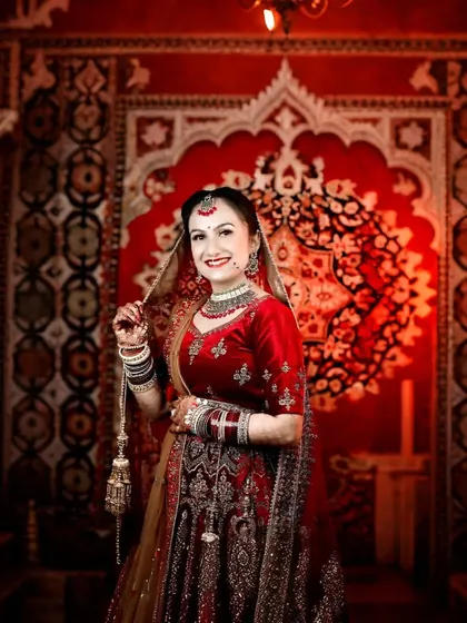 This bride's happy smile lights up the frame. I captured this against a richly decorated backdrop, making the red of her lehenga even more vibrant.