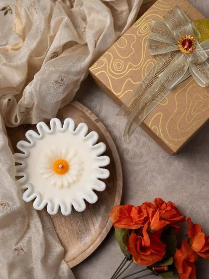 This beautiful daisy-shaped candle is set in a real Indian marble urli. It's an elegant and timeless piece that makes a wonderful Diwali gift.