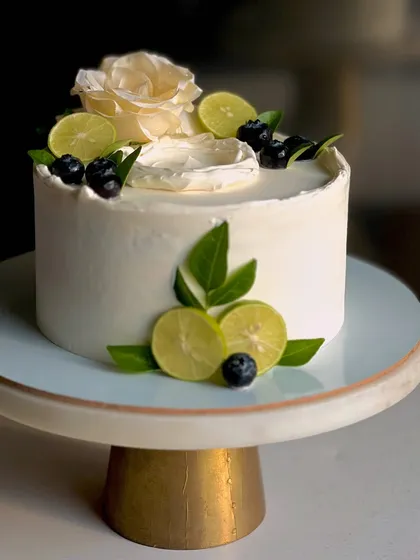 My most popular creation, the signature Italian Lemon & Blueberry cake. I offer many design variations, all featuring fresh blueberries, zesty lime, and smooth buttercream.