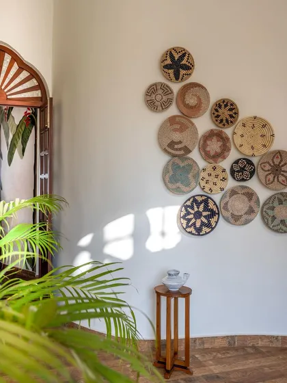 For this Goan holiday villa, we transformed the staircase into a bright and welcoming feature. We replaced a dark, heavy structure with a lighter design, adding a collection of woven baskets to the wall to create an earthy, relaxed vacation vibe.