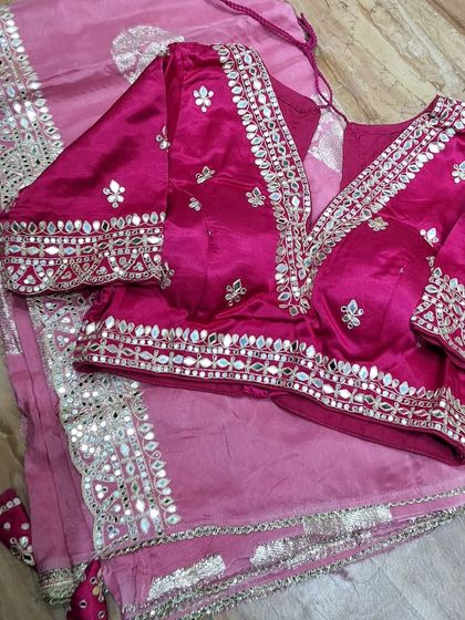 This blouse and saree set in shades of pink showcases beautiful gota patti and mirror work. I work closely with you to ensure the blouse design, from the neckline to the sleeve details, is exactly what you envision.