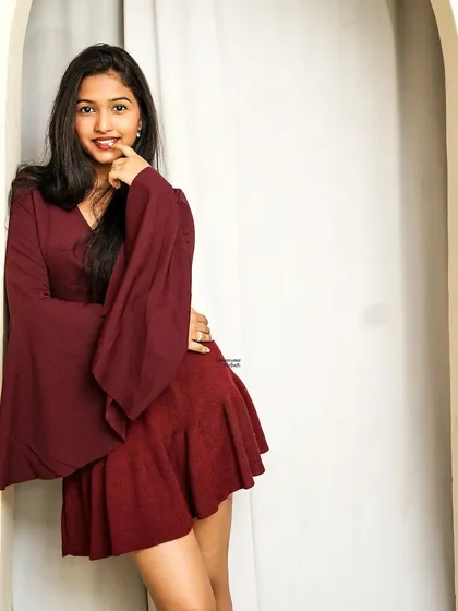 A playful and confident pose in a doorway, this shot captures a moment of fun and style.