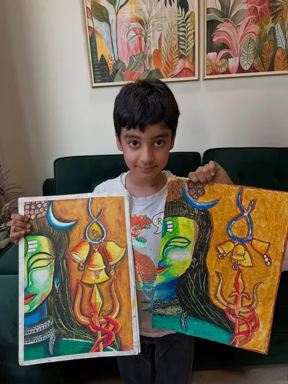 The journey of an artist. This student proudly shows his original Shiva-inspired painting alongside his reference, showing his progress and dedication.