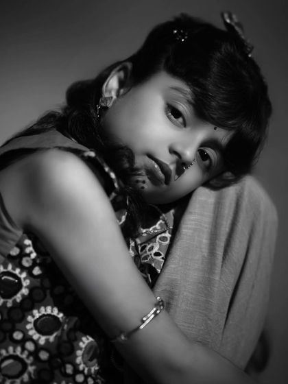 A soft and gentle black and white close-up. This portrait captures a quiet, innocent moment, showing a completely different emotional range.