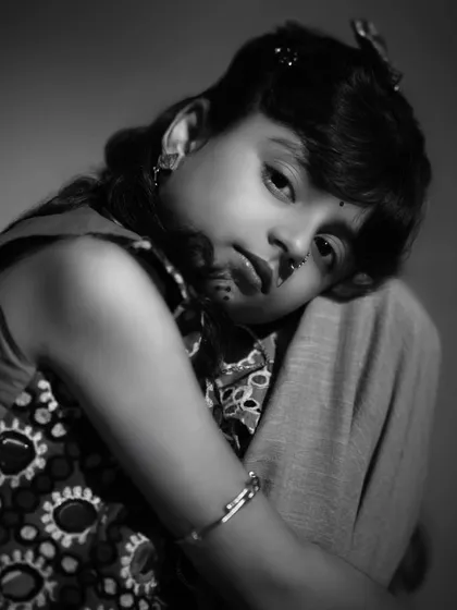 A soft and gentle black and white close-up. This portrait captures a quiet, innocent moment, showing a completely different emotional range.