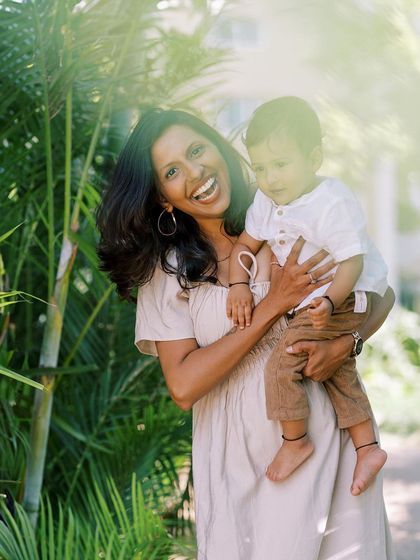 A joyful, candid shot of a mother laughing while holding her son. Her happiness is infectious and makes for a beautiful photo.