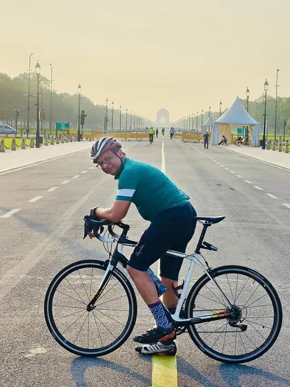 Posing with his bike, with India Gate visible in the distance down Kartavya Path.