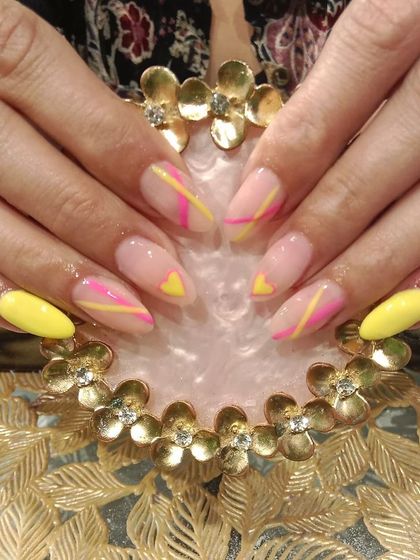 A playful and geometric design with neon yellow and pink lines and heart shapes over a neutral base.