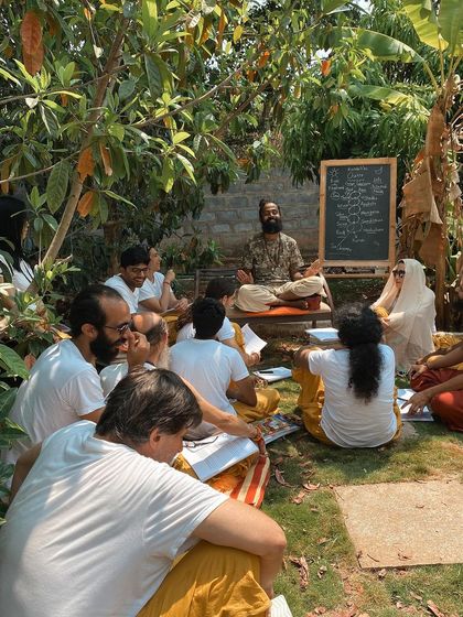 An outdoor philosophy class under the banyan tree. I believe in teaching in a way that is alive and connected to our surroundings. Here, I explain that yoga is the study of "you" to realize you are not just "you."