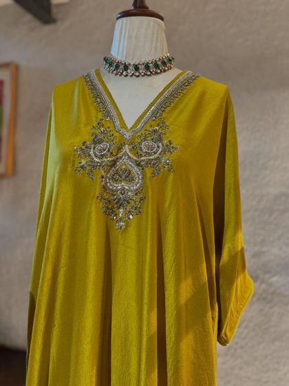 A stunning mustard yellow velvet kaftan by Jayanti Reddy, featuring her signature intricate silver embroidery on the neckline.