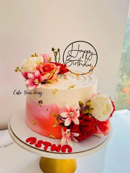 A creation almost too pretty to eat. This watercolor-style cake is adorned with beautiful red and pink flowers.