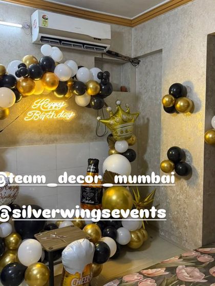 Another angle of the black and gold balloon arch, showing how it can transform a room and create a festive focal point.