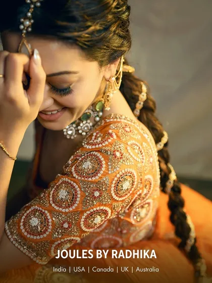A candid, joyful moment with Hansika Motwani, her smile as bright as the jewels she wears. The side view highlights the intricate details of her earrings and hair accessories.