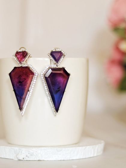 This is one of my favorite shots. The sharp, geometric cut of these gemstone earrings is contrasted with the soft curve of a simple ceramic cup, creating a modern and artistic statement.