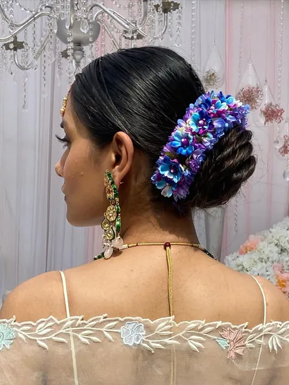 A close-up of the hydrangea floral bun, showing the rich color and texture it adds to the hairstyle.