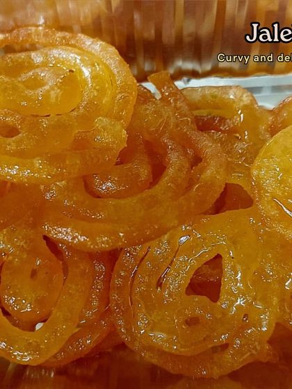 A close-up view of our curvy and delicious Jalebis. You can almost feel the crispy texture and see the syrupy glaze. We fry these fresh for event orders to ensure they are served hot.