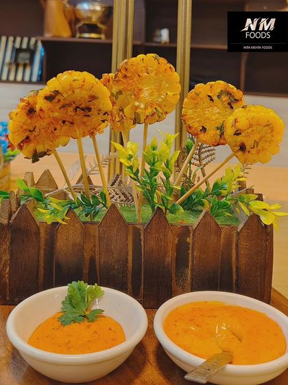These corn lollipops are a fun and creative vegetarian starter. Served in a planter-style box with dipping sauces, they are always a hit with guests of all ages.