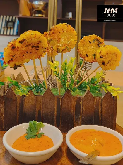 These corn lollipops are a fun and creative vegetarian starter. Served in a planter-style box with dipping sauces, they are always a hit with guests of all ages.