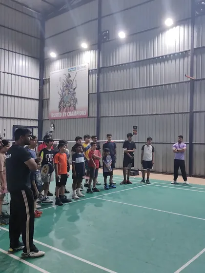 My coaches and I addressing a group of students on the court. I use these opportunities to share knowledge, build team spirit, and motivate my players.