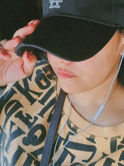 A close-up, 'no face' shot focusing on a graphic sweatshirt and cap, perfect for a relaxed, minimalist vibe.