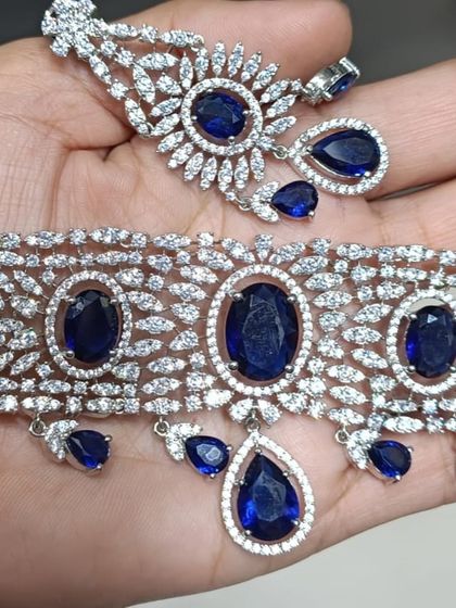 A heavy American Diamond choker with large oval sapphire-blue stones. This is a very royal and eye-catching design.