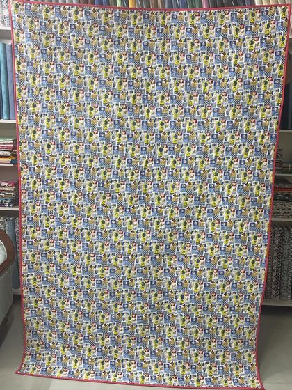 The fun, cartoon-themed backing fabric for the scrappy quilt.