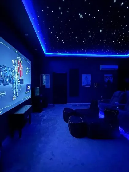 The same gaming room can transform its mood instantly with smart lighting control. Here, a cool blue theme is activated for a different game, showcasing how flexible and personalized your entertainment space can be.