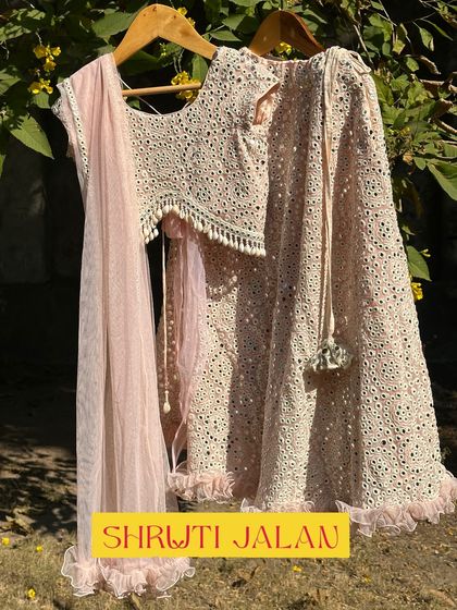 This blush pink lehenga features intricate mirror work and a delicate net dupatta. I designed it to be elegant and comfortable, perfect for a little flower girl or a young wedding guest.