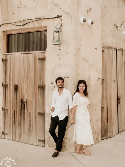 A classic, romantic pose against the rustic walls and wooden doors of Old Dubai.