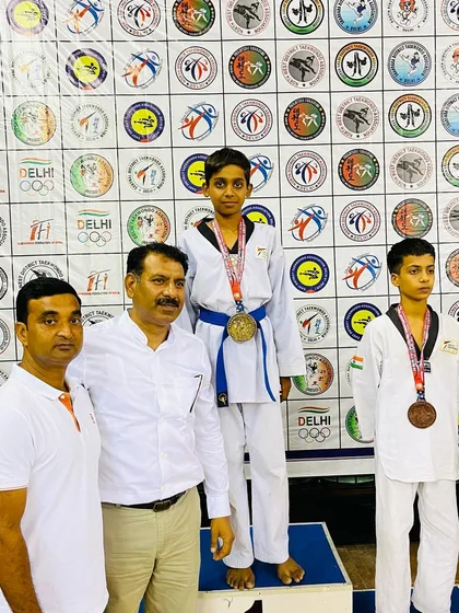 Bhanu Pratap standing tall on the podium with his gold medal from the 39th Delhi State Taekwondo Championship.