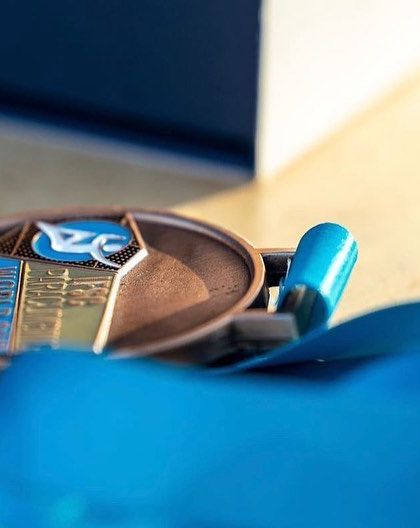 A close-up of the World Cup bronze medal from Villars. Each one represents countless hours of training, dedication, and the support of our amazing community.