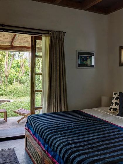 The Garden Room's bed looks out onto a private garden space, emphasizing a constant connection with nature.