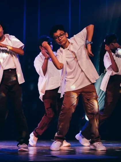 Focus, energy, and teamwork on full display. This shot captures our junior dancers completely in the zone during their stage performance, showcasing the discipline and passion they develop in our classes.