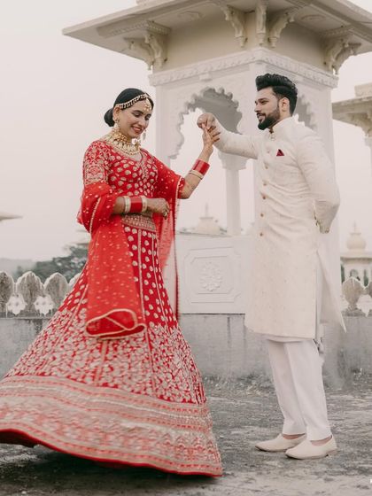 A dance of joy and new beginnings. We love seeing our grooms celebrate, and this beautiful shot captures the elegance of our classic white sherwani in motion.